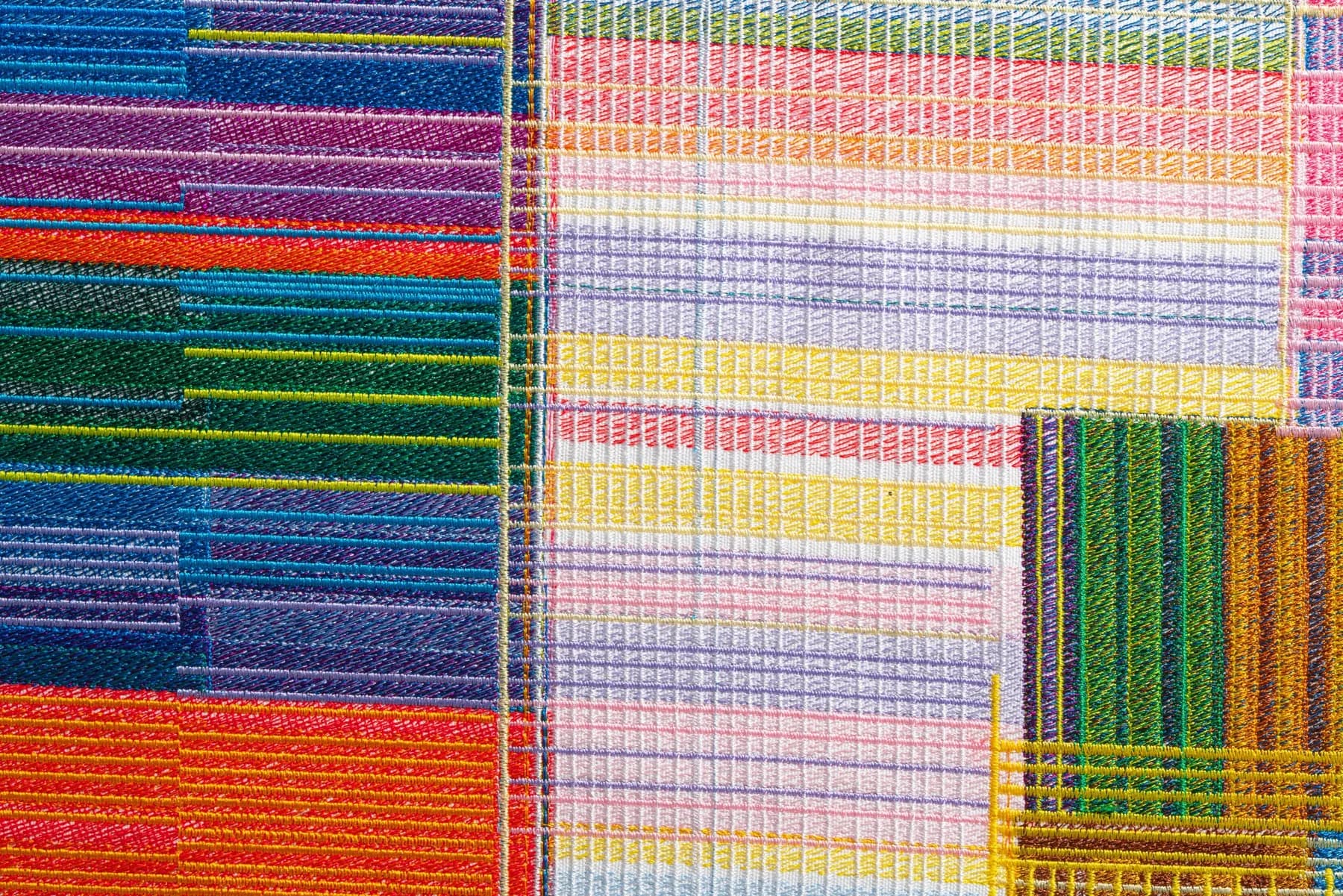 Summer, folded (detail) — close-up of multicoloured embroidered threads running in parallel and intersecting bands